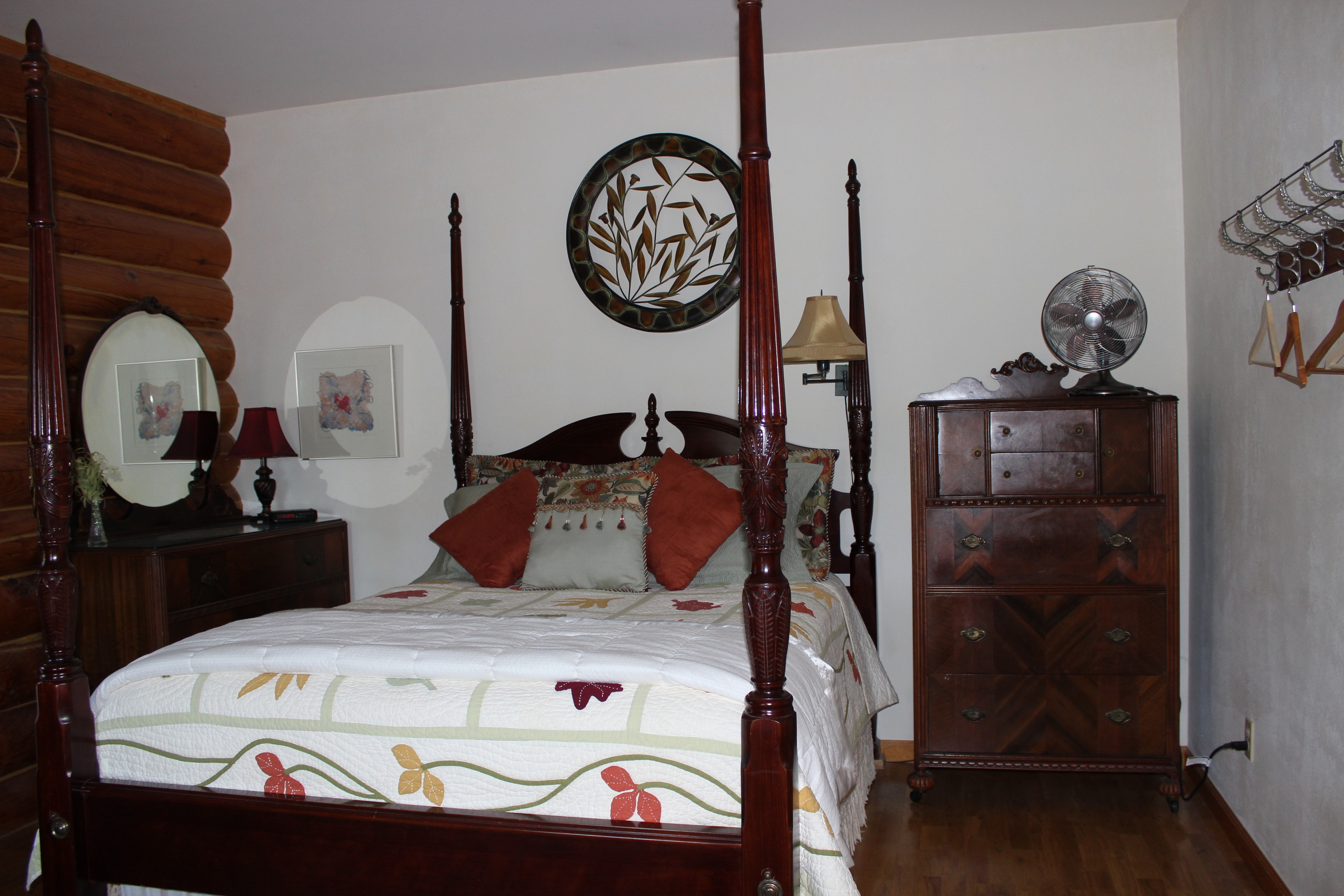 Queen sized mahogany 4 poster bed, with matching dresser and tallboy.  Pottery Barn autumn leaf quilt.