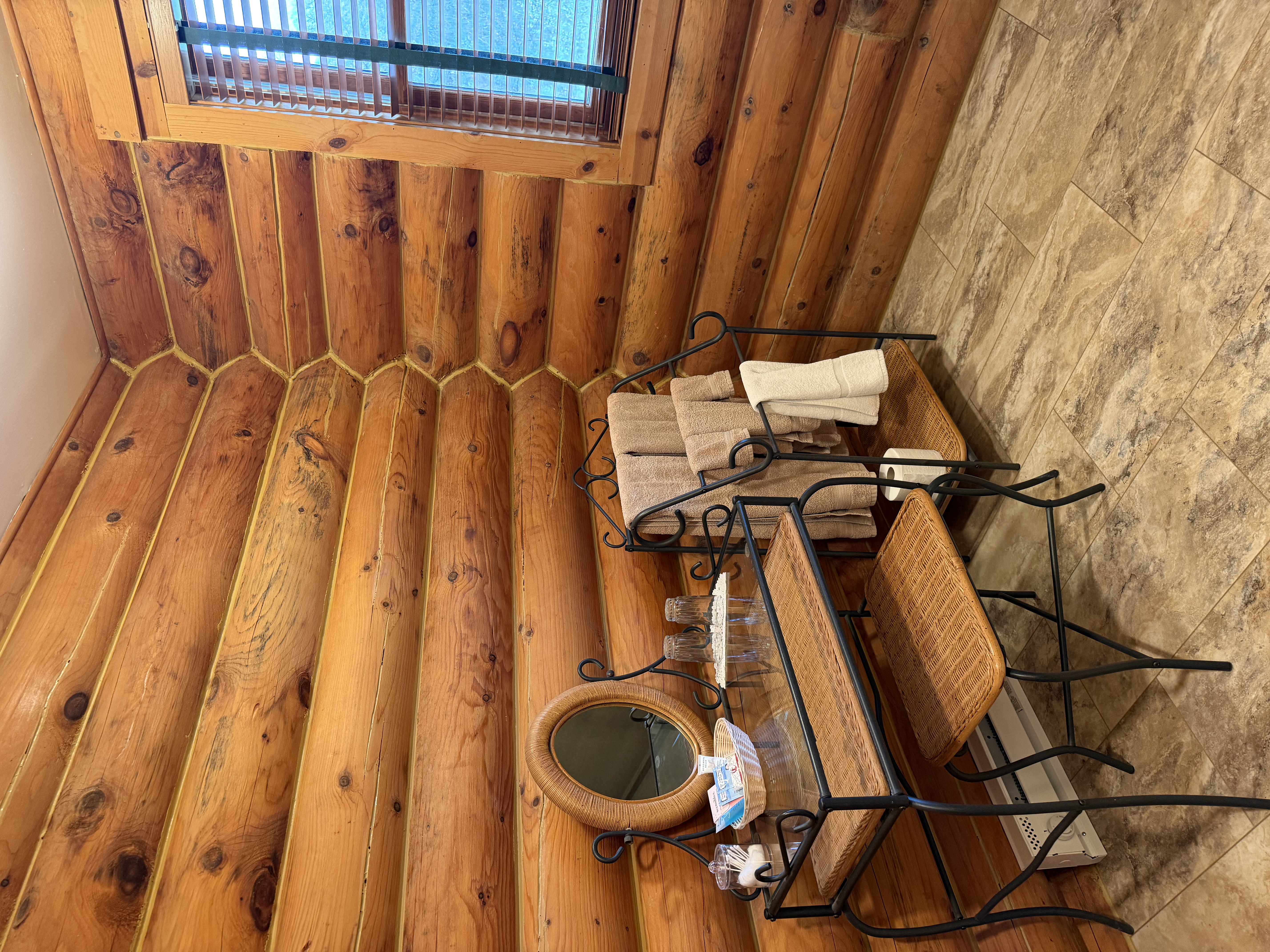 Large bathroom with walk in shower and wicker vanity with mirror